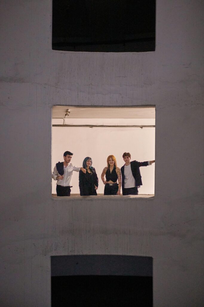 Group of four diverse young adults posing confidently in an urban setting in Istanbul.